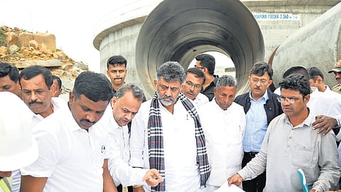 Deputy Chief Minister DK Shivakumar inspects pipe work near Madeshwara village in Doddaballapura taluk on Saturday