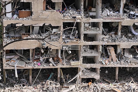 Rescue workers inspect the site struck by a direct missile strike launched from Iran in Tel Aviv, Israel, on Sunday, June 22, 2025.