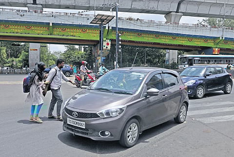 Pedestrians struggle to cross the road at Tarnaka junction