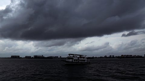 Dark clouds roll up in the sky above Kochi backwards.
