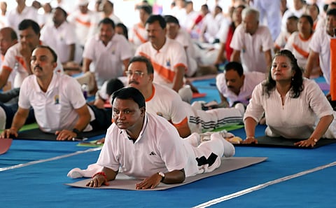 Chief Minister Mohan Charan Majhi performing yoga on the occasion of International Yoga Day at Kalinga Stadium in Bhubaneswar on Saturday.
