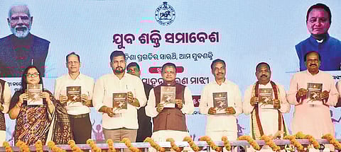 CM Mohan Charan Majhi and other guests unveiling a booklet at the event