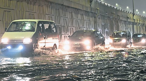 Vehicles wade through water after heavy rain in Delhi.