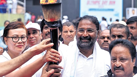 Sports Minister Vakiti Srihari holds the Olympic Torch during the Olympic Day Run in Hyderabad on Monday