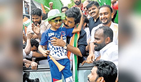 Shoukath with a young supporter during his victory march.