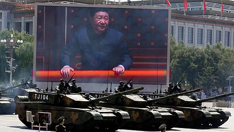 Chinese President Xi Jinping is displayed on a screen as Type 99A2 Chinese battle tanks take part in a parade commemorating the 70th anniversary of Japan's surrender during World War II held in front of Tiananmen Gate in Beijing on Sept. 3, 2015.