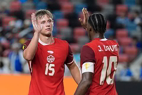 Canada forward Jonathan David (10) celebrates with defender Luc De Fougerolles (15) after scoring during a CONCACAF Gold Cup soccer match against El Salvador in Houston, Tuesday, June 24, 2025.