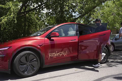 A rider boards a driverless Tesla Robotaxi, a ride booking service, Sunday, June 22, 2025, in Austin, Texas.