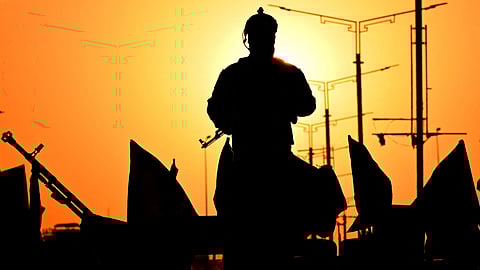 An Iraqi soldier stands guard as people march during celebrations to mark the ceasefire between Israel and Iran in the southern city of Basra on June 24, 2025.