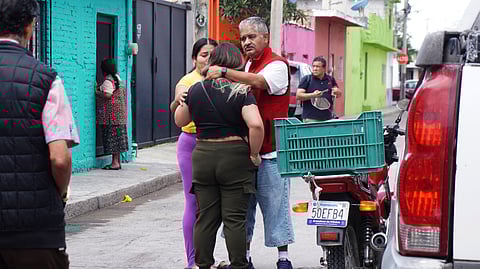 Residents comfort each other after a shooting at the Barrio Nuevo neighbourhood in Irapuato, Guanajuato state, Mexico, on June 25, 2025.