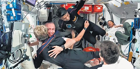 (L) ISS crew greet Shubhanshu Shukla (C) and other astronauts after docking of their spacecraft;(L) ISS crew greet Shubhanshu Shukla (C) and other astronauts after docking of their spacecraft