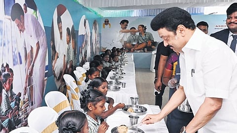 Tamil Nadu CM Stalin with a child of St. Anne's Primary School at Keezhacheri in Tiruvallur district during the expansion of Tamil Nadu government's flagship Chief Minister's breakfast scheme.