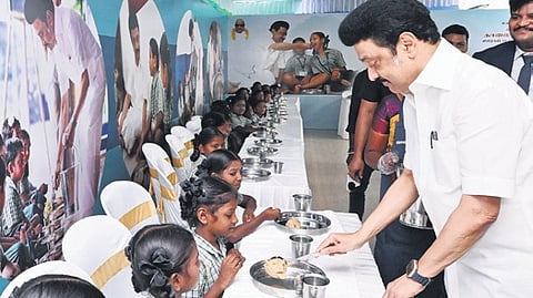 Tamil Nadu CM Stalin with a child of St. Anne's Primary School at Keezhacheri in Tiruvallur district during the expansion of Tamil Nadu government's flagship Chief Minister's breakfast scheme.
