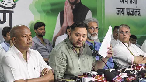 RJD leader Tejashwi Yadav with Bihar Congress President Rajesh Kumar (L).