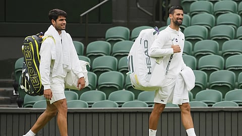Novak Djokovic of Serbia, right and Carlos Alcaraz of Spain, left, arrive for a practice session on Centre Court at the All England Lawn Tennis and Croquet Club, ahead of the Wimbledon Championships in London, Thursday, June 26, 2025.