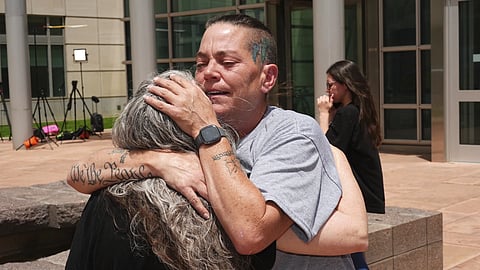 Crystina Page, right, hugs Beth Mosley, who both had retained the services of a Colorado funeral home owner who stashed nearly 190 decomposing bodies, after the owner was sentenced to 20 years prison on federal fraud charges, Friday, June 27, 2025, in Denver.