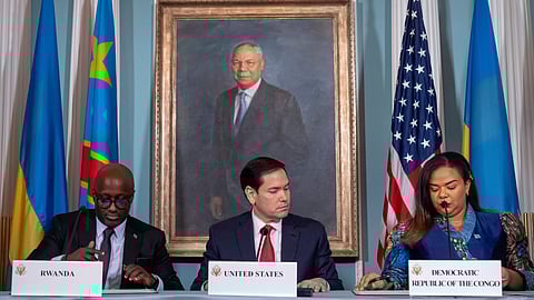 Secretary of State Marco Rubio, center, watches as Rwanda's Foreign Minister Olivier Nduhungirehe, left, and Democratic Republic of the Congo's Foreign Minister Therese Kayikwamba Wagner, right, sign a peace agreement at the State Department, Friday, June 27, 2025, in Washington.