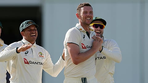 Australia's Josh Hazlewood, center, celebrates taking the wicket of West Indies' Brandon King on day three of the first cricket Test match at Kensington Stadium in Bridgetown, Barbados, Friday, June 27, 2025.