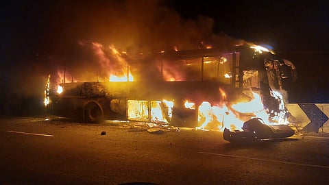A private electric bus travelling from Trichy to Coimbatore caught fire after colliding with a road divider.
