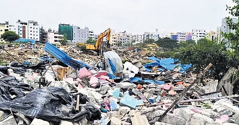 An earthmover clears the debris after the razing of structures within the FTL limits of Sunnam Cheruvu in Hyderabad on Monday