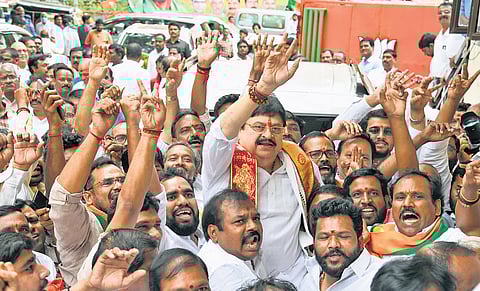 Former MLC Ramchandar Rao gets a rousing reception as he arrives at the BJP office at Nampally, Hyderabad, to submit his nomination papers on Monday.