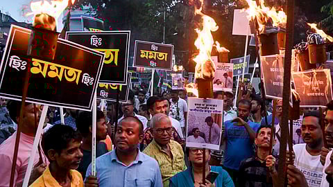 BJP activists participate in a torch rally to protest against the alleged gangrape of a law student in her college, in Kolkata, Sunday, June 29, 2025.