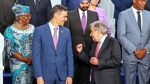 Spain's Prime Minister Pedro Sanchez, left, speaks with United Nations Secretary-General Antonio Guterres, as they pose for a photo with nation leaders and representatives, at the start of the four-day Financing for Development meeting, in Seville, Spain, Monday, June 30, 2025.