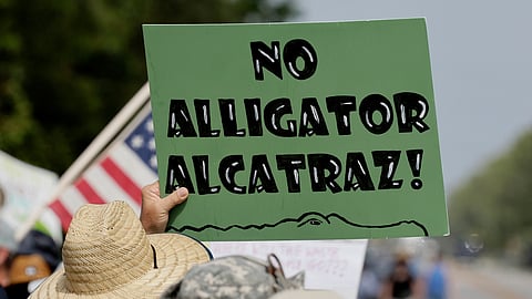Environmental advocates and protesters at the Dade-Collier Training and Transition Airport on Tamiami Trail E, Ochopee, Fla., on Saturday, June 28, 2025, object to the "Alligator Alcatraz" being built at the facility.