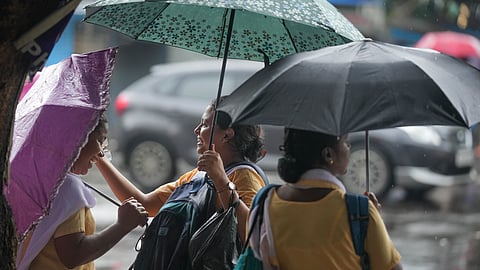 Students wait amid rainfall, in Kolkata, Monday, June 30, 2025