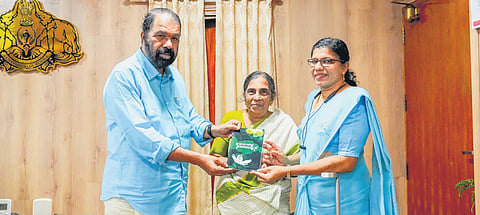 Chandramani C handing over a copy of her collection of poems to General Education Minister V Sivankutty. Former Neyyatinkara councillor Jaya Dali is also seen