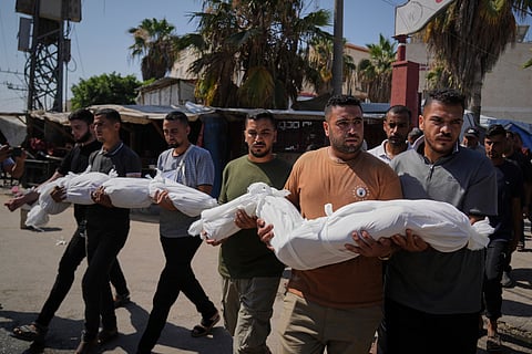 Relatives carry the bodies of two Palestinian sisters Mira, 8, and Sabah Bashir, 10, who were killed in an Israeli army airstrike of the Gaza Strip, during their funeral in Deir al-Balah, Wednesday, July 2, 2025.
