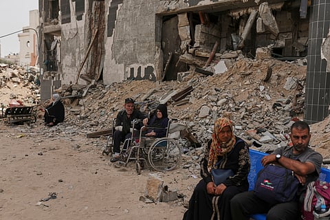 Kidney patients sit amid the destruction caused by the Israeli army at Shifa Hospital compound in Gaza City on Tuesday, July 1, 2025, as they wait to leave after the facility suspended its dialysis unit services due to fuel shortages needed to power its generators.