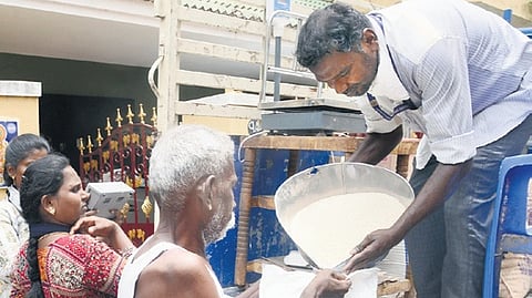 Rice being distributed to an elderly man on his doorstep at Velachery in Chennai on Wednesday
