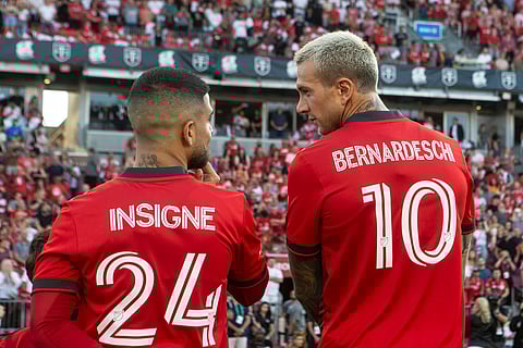 Toronto FC's Lorenzo Insigne (24) talks with teammate Federico Bernardeschi (10) before an MLS soccer match against Charlotte FC in Toronto, July 23, 2022.