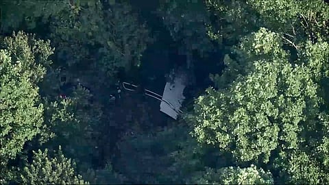 This image taken from video provided by WPVI-TV/6ABC shows a small skydiving aircraft that went off the end of a runway at Cross Keys Airport in Gloucester County, N.J., on Wednesday evening, July 2, 2025.