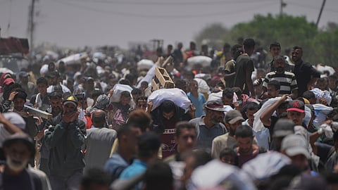 FILE - Palestinians carry bags containing food and humanitarian aid packages delivered by the Gaza Humanitarian Foundation, a U.S.-backed organization, in Rafah, southern Gaza Strip, Monday, June 9, 2025
