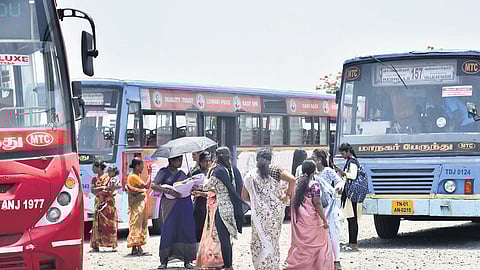 Commuters carrying luggage are forced to endure the scorching heat and rain due to the absence of shelters.