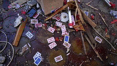Blood, rubble, and a deck of cards lie scattered in a café after it was hit by an Israeli airstrike that killed more than 30 people near the port in Gaza City, Monday, June 30, 2025.