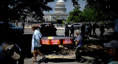 Demonstrators carry cardboard caskets in front of the U.S. Capitol in protest of President Donald Trump's tax breaks and spending cuts package, Monday, June 30, 2025, in Washington.