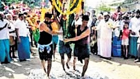 Devotees who had taken vows participating in the traditional fire-walking ceremony (Thee Mithi) at the chavadi on Sunday