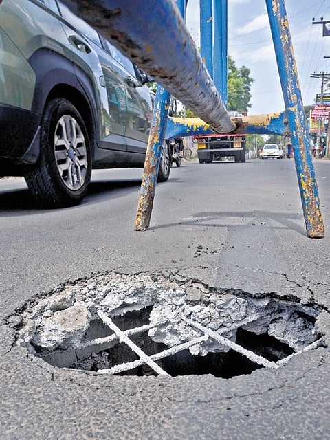 The manhole is in the middle of the road. Although a barricade has been placed, it is not visible at night.