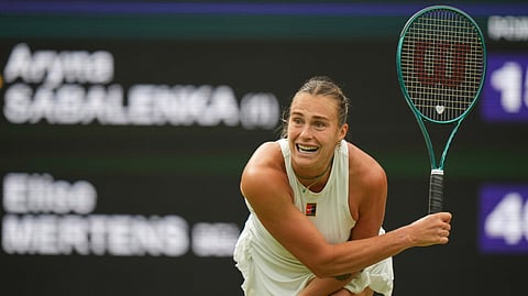 Aryna Sabalenka of Belarus serves to Belgium's Elise Mertens during a fourth round women's singles match at the Wimbledon Tennis Championships in London, Sunday, July 6, 2025.