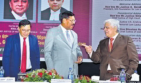 Chief Justice of India B R Gavai shares a light moment with Justice Devan Ramachandran of the Kerala High Court during the 11th Justice V R Krishna Iyer Memorial Law Lecture. Kerala HC Chief Justice Nitin Jamdar is also seen.