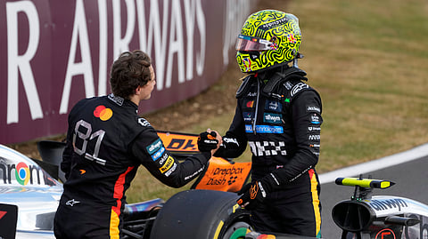 McLaren driver Lando Norris of Britain, right, is congratulated by his teammate Oscar Piastri of Australia after winning the British Formula One Grand Prix race at the Silverstone racetrack in Silverstone, England, Sunday, July 6, 2025.