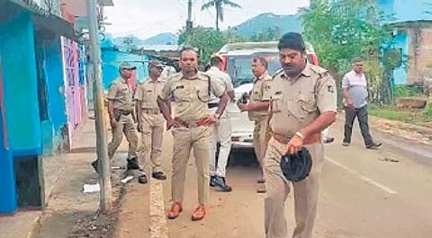 Police inspecting the crime scene outside the deceased’s house.