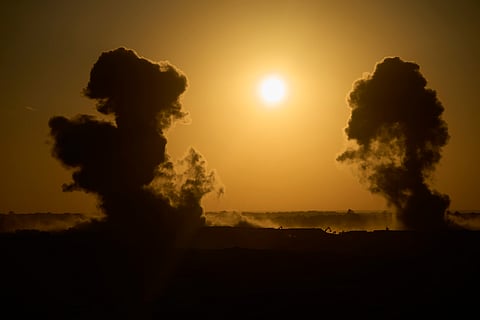Smoke rises following an explosion near destroyed buildings inside the Gaza Strip, as seen from southern Israel, on Sunday, July 6, 2025.