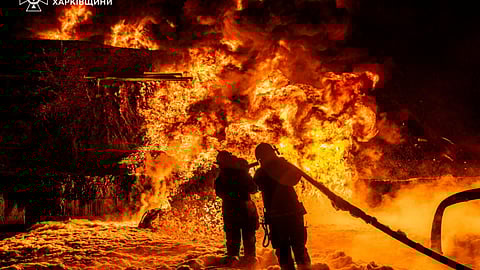 In this photo provided by the Ukrainian Emergency Service, emergency services personnel work to extinguish a fire following a Russian attack in Kharkiv region, Ukraine, Saturday, July 5, 2025