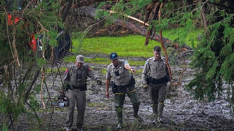 Officials inspect an area at Camp Mystic along the banks of the Guadalupe River after a flash flood swept through the area Sunday, July 6, 2025, in Hunt, Texas.