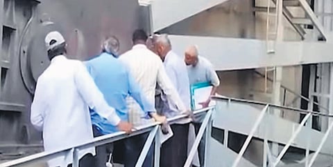 Gates expert Kannaiah Naidu along with irrigation officials pursuing the condition of Srisailam dam gates on Sunday.