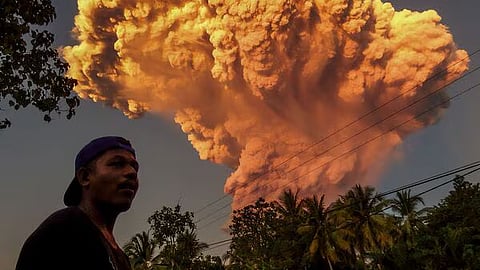 A villager watches the eruption of Mount Lewotobi Laki-Laki as seen from Talibura village in Sikka, East Nusa Tenggara, on June 17, 2025.